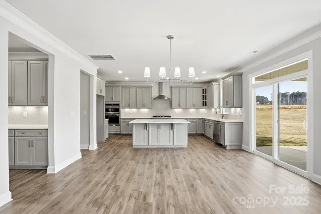 a large kitchen with a lot of counter space windows and appliances