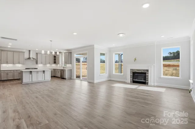 a view of kitchen with furniture and wooden floor
