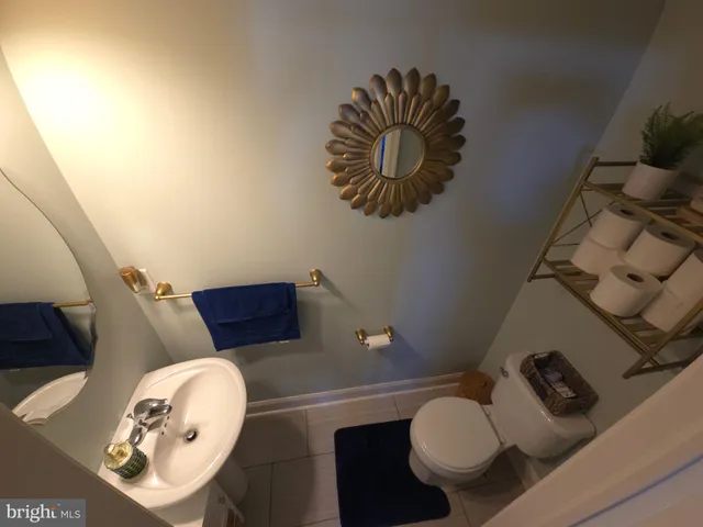 a bathroom with a toilet and a mirror