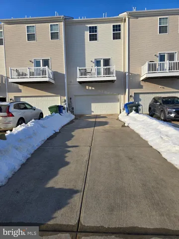a living room with stainless steel appliances kitchen island granite countertop a stove a sink and a refrigerator