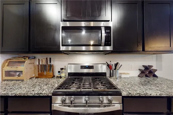 a kitchen with a stove and cabinets
