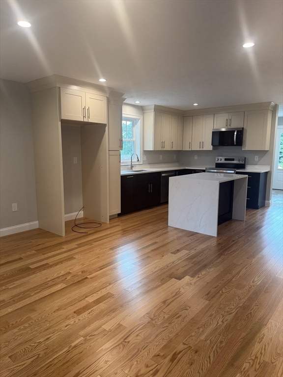27 James Road, Unit 2 Upton, MA 01568 - Photo 2 of 31 a kitchen with stainless steel appliances kitchen island granite countertop a stove a sink and a refrigerator