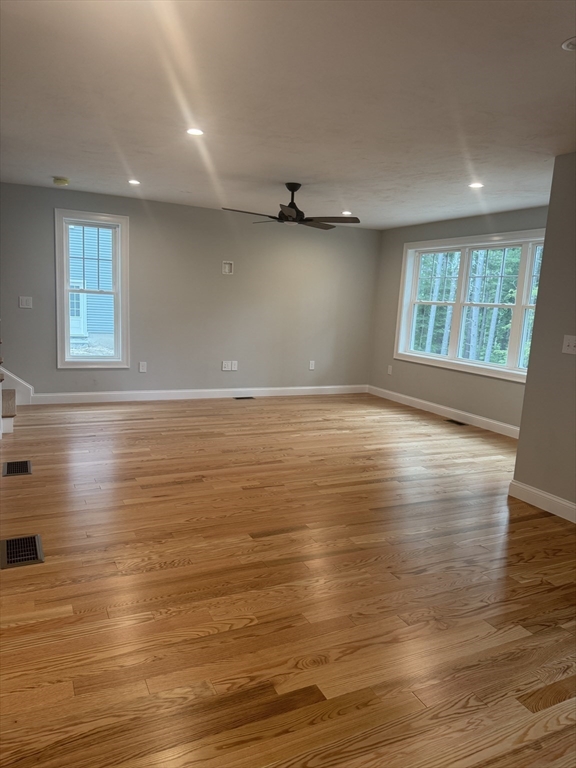 27 James Road, Unit 2 Upton, MA 01568 - Photo 4 of 31 an empty room with wooden floor and windows