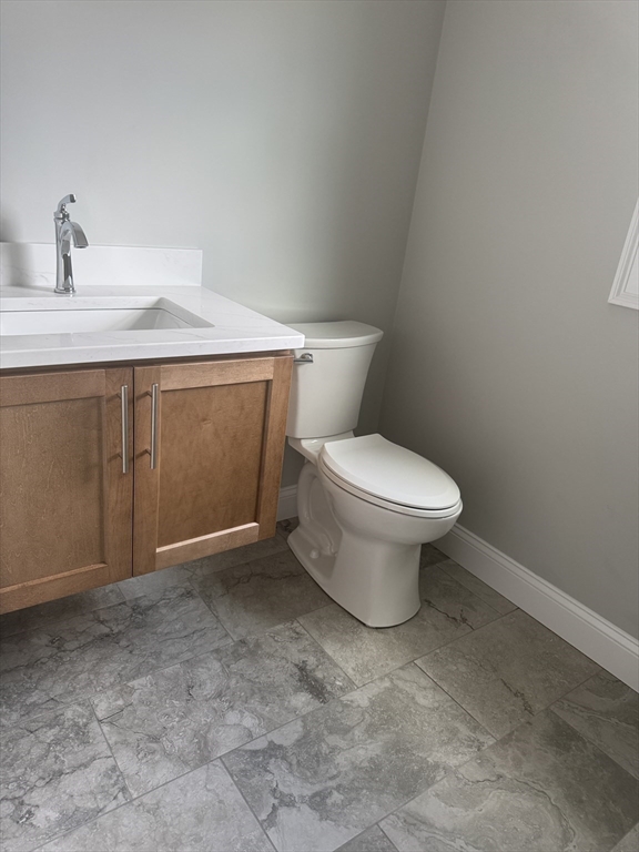 27 James Road, Unit 2 Upton, MA 01568 - Photo 6 of 31 a bathroom with a toilet sink and vanity