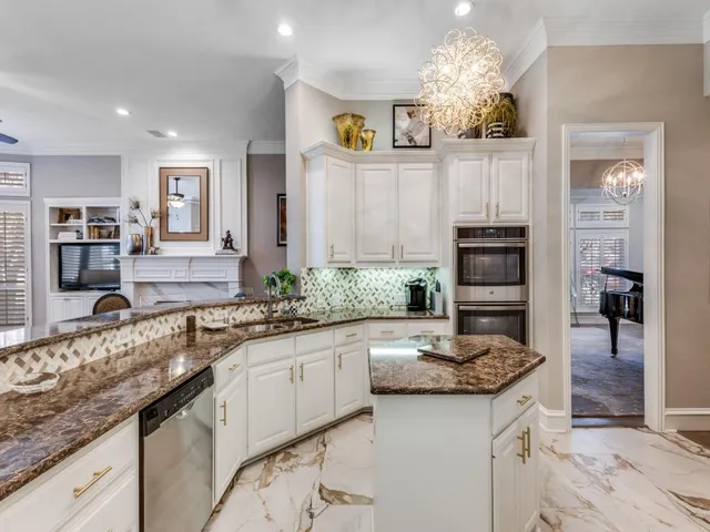 a kitchen with granite countertop a sink and cabinets