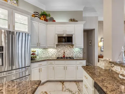 a kitchen with granite countertop a sink and cabinets