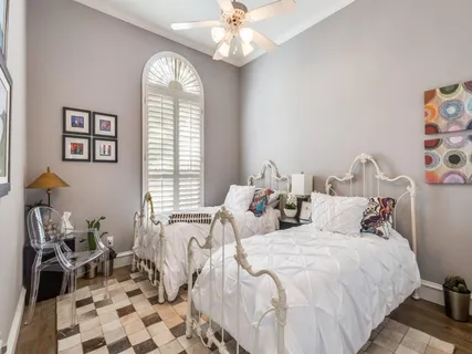 a bedroom with three beds and a window