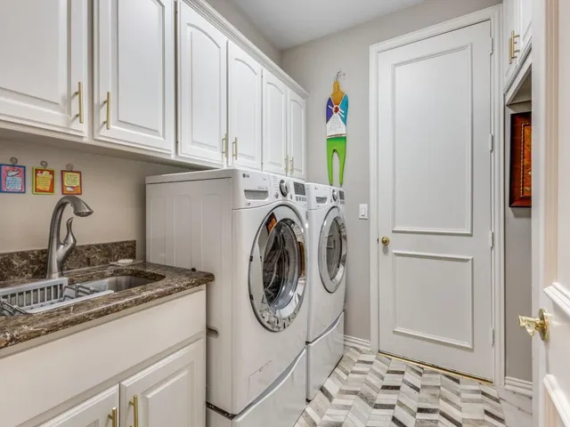 a utility room with sink dryer and washer