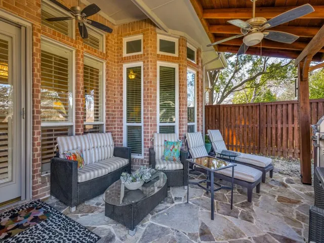 a balcony with furniture and a potted plant