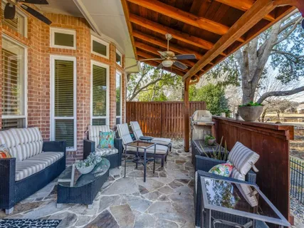 a outdoor living space with patio furniture and wooden floor