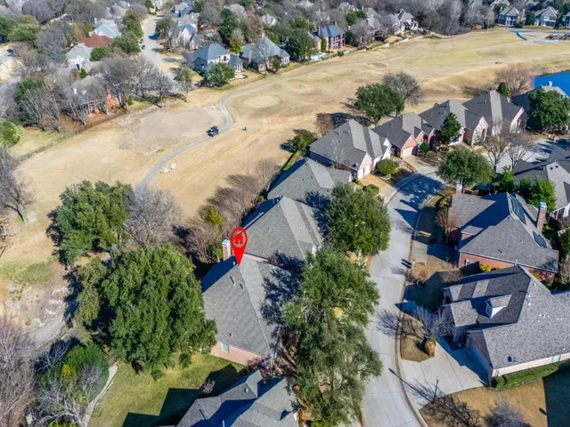 an aerial view of residential houses with outdoor space