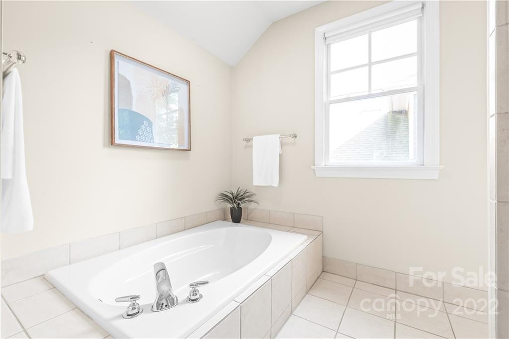 2208 Club Road Charlotte, NC 28205 - Photo 18 of 25 a bathroom with a bathtub and a window