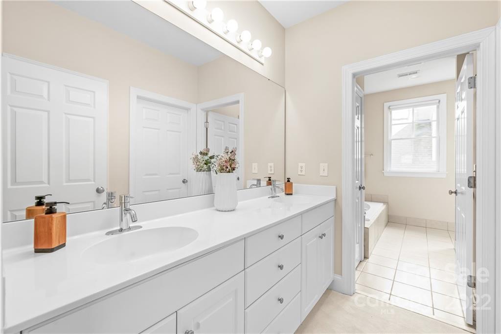 2208 Club Road Charlotte, NC 28205 - Photo 19 of 25 a bathroom with double sink and a mirror