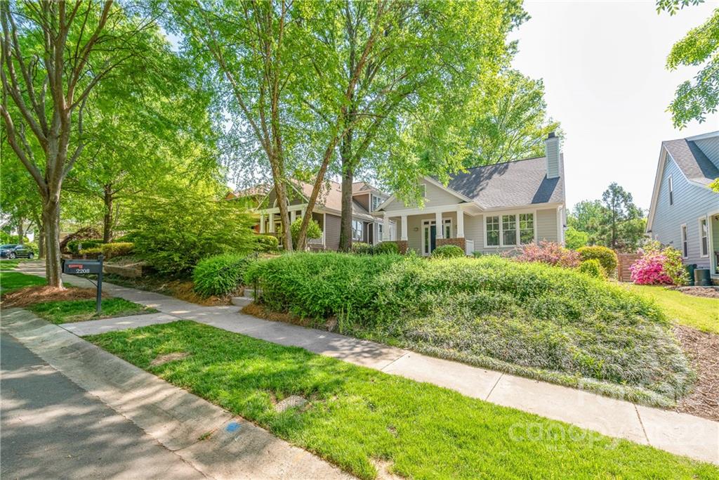 2208 Club Road Charlotte, NC 28205 - Photo 2 of 25 a front view of a house with a yard and a garage