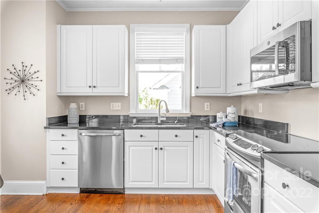 2208 Club Road Charlotte, NC 28205 - Photo 9 of 25 a kitchen with granite countertop a sink cabinets stainless steel appliances and a window