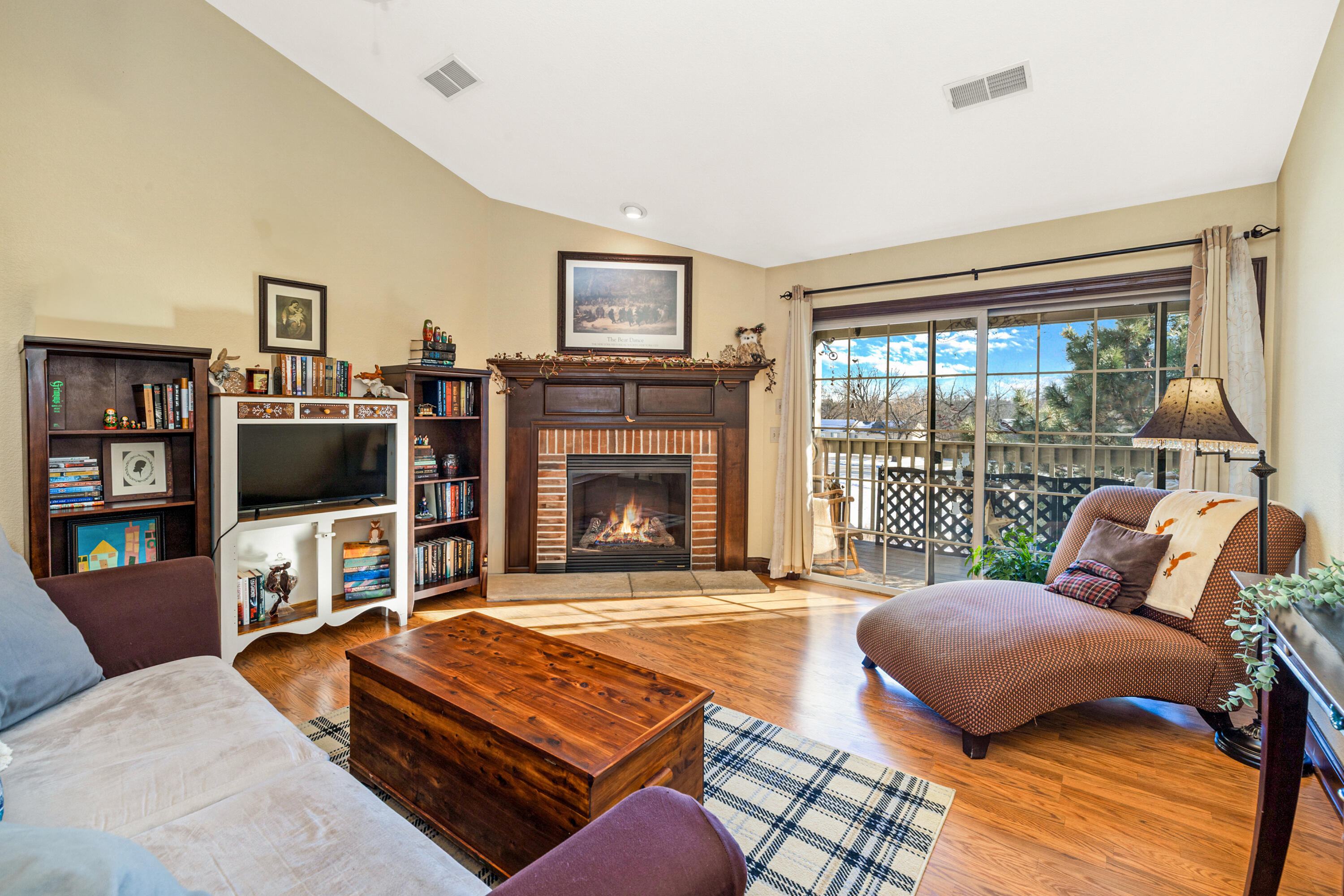 4869 South Forest Ridge Drive, Unit 17 New Berlin, WI 53151 - Photo 3 of 25 Sunny south-facing windows and cozy gas fireplace