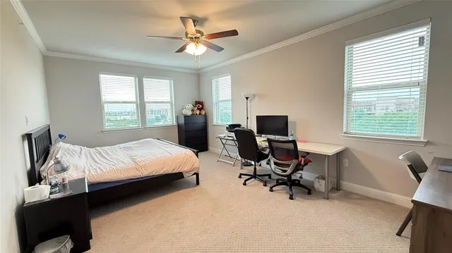 a bedroom with a bed gym equipment and a desk
