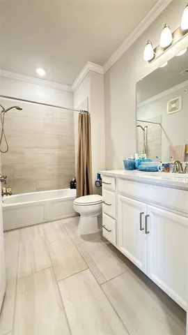 a bathroom with a double vanity sink toilet and shower