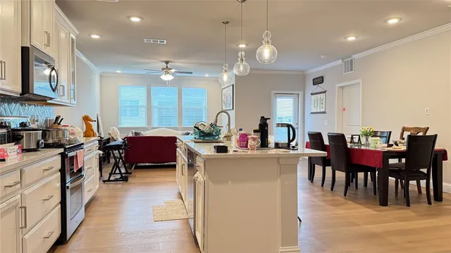 a view of a dining room with furniture and chandelier