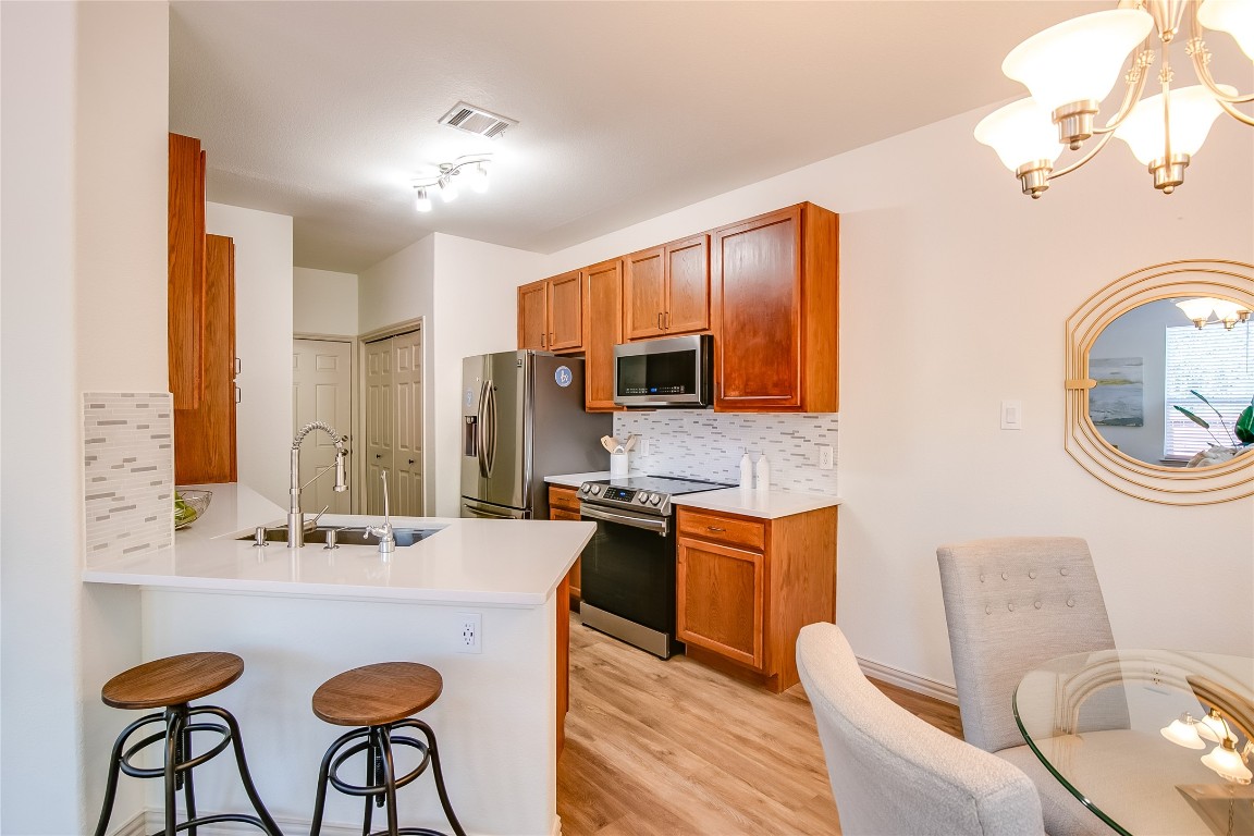 2410 Great Oaks Drive, Unit 804 Round Rock, TX 78681 - Photo 13 of 37 a bathroom with a sink a table and chairs