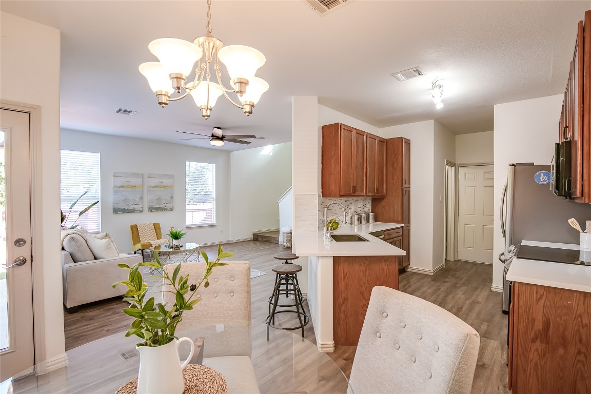 2410 Great Oaks Drive, Unit 804 Round Rock, TX 78681 - Photo 37 of 37 a living room with furniture a chandelier and a dining room