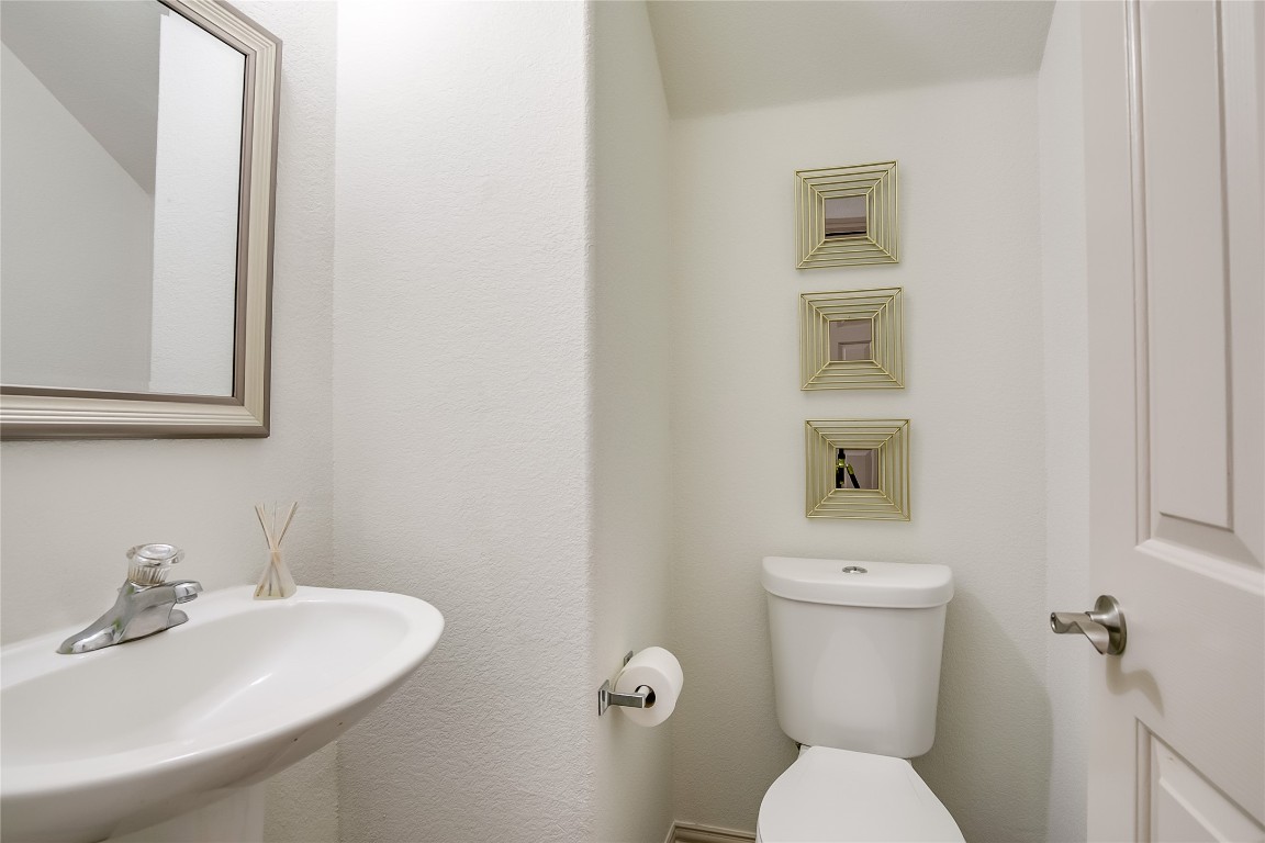2410 Great Oaks Drive, Unit 804 Round Rock, TX 78681 - Photo 17 of 37 a bathroom with a sink mirror and toilet