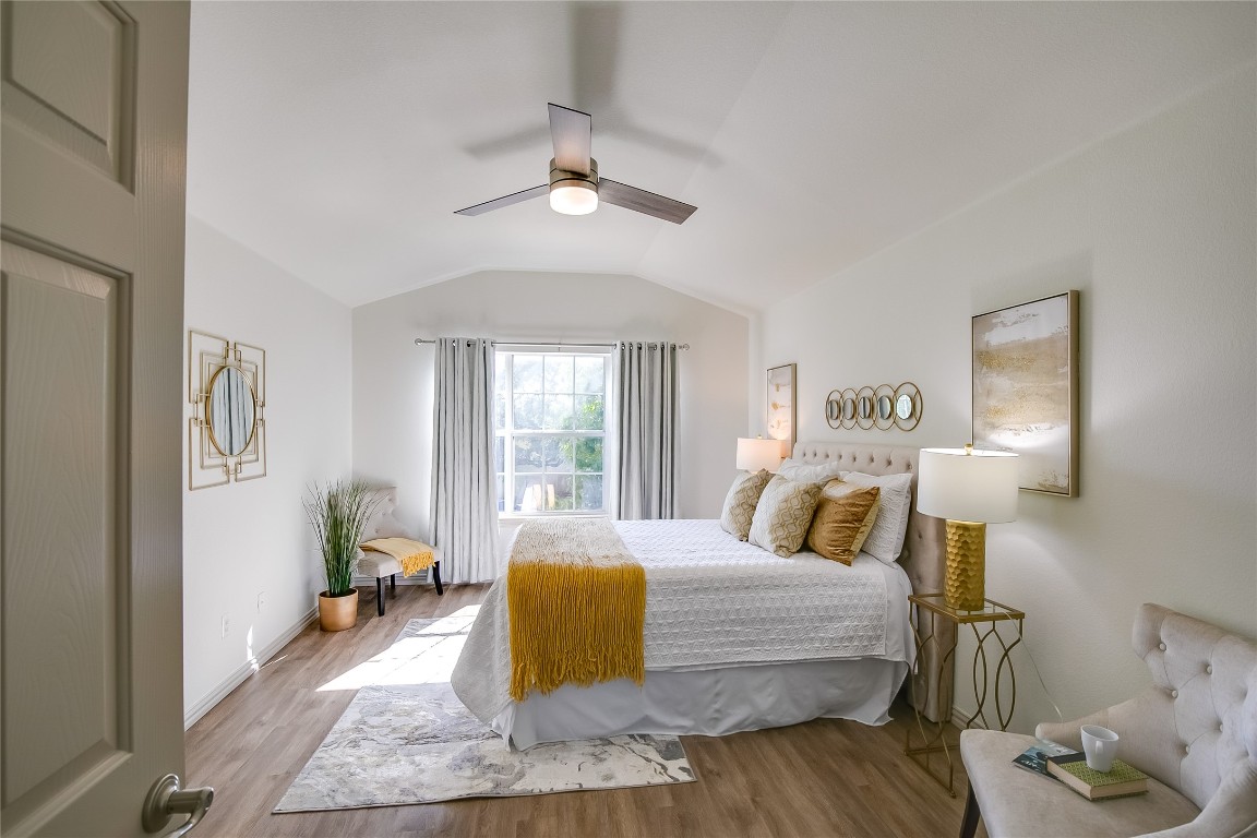 2410 Great Oaks Drive, Unit 804 Round Rock, TX 78681 - Photo 18 of 37 a bedroom with a bed and a chandelier