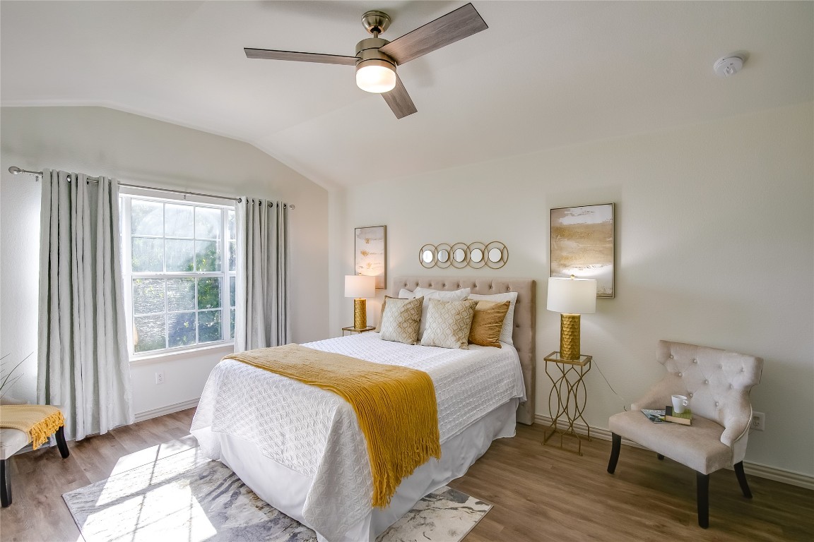 2410 Great Oaks Drive, Unit 804 Round Rock, TX 78681 - Photo 19 of 37 a bedroom with a bed wooden floor and window