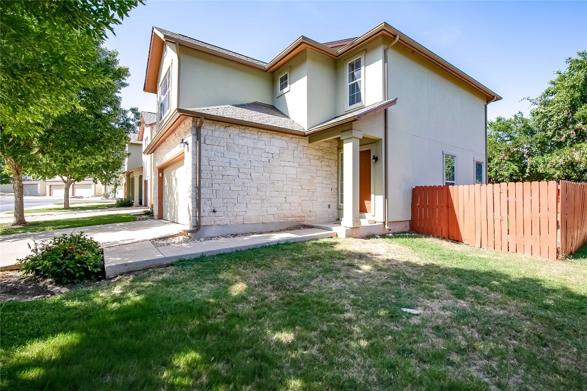 2410 Great Oaks Drive, Unit 804 Round Rock, TX 78681 - Photo 2 of 37 a view of a house with a yard and garage