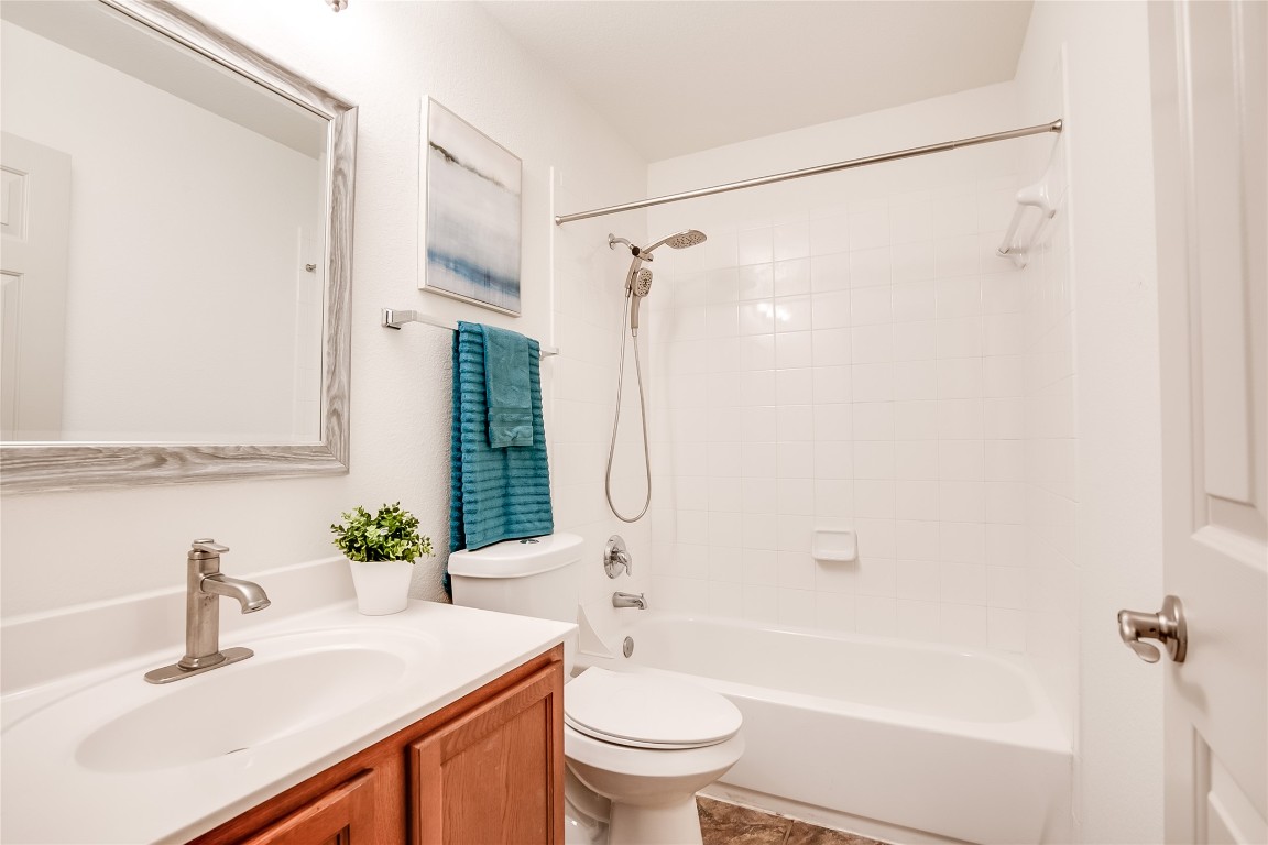2410 Great Oaks Drive, Unit 804 Round Rock, TX 78681 - Photo 24 of 37 a bathroom with a sink a toilet and shower