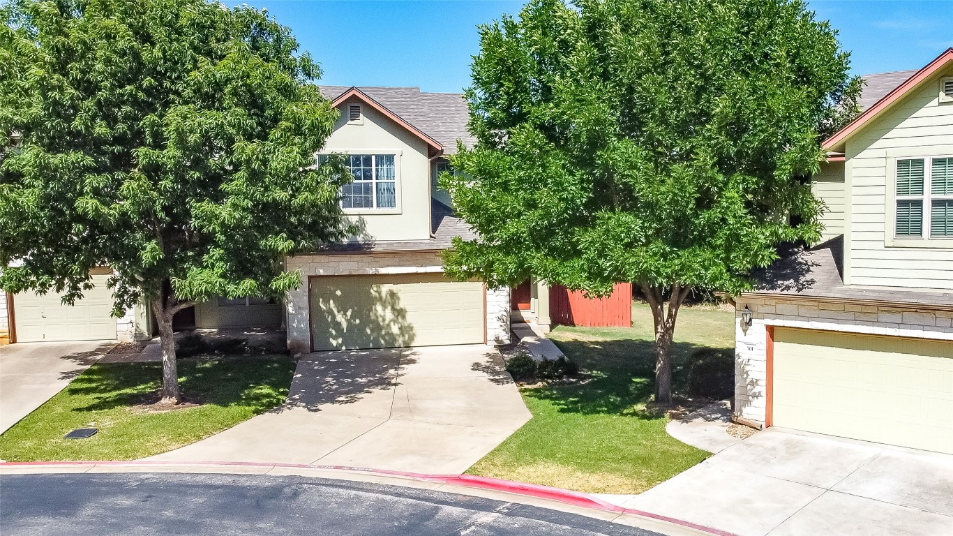 2410 Great Oaks Drive, Unit 804 Round Rock, TX 78681 - Photo 3 of 37 a front view of a house with a yard and trees