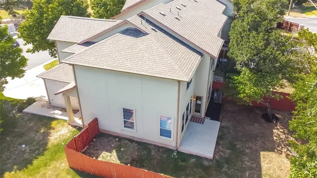 a view of house with pool and sitting area