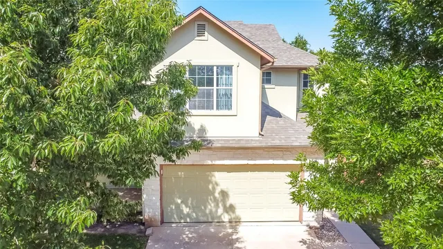 a view of house with backyard