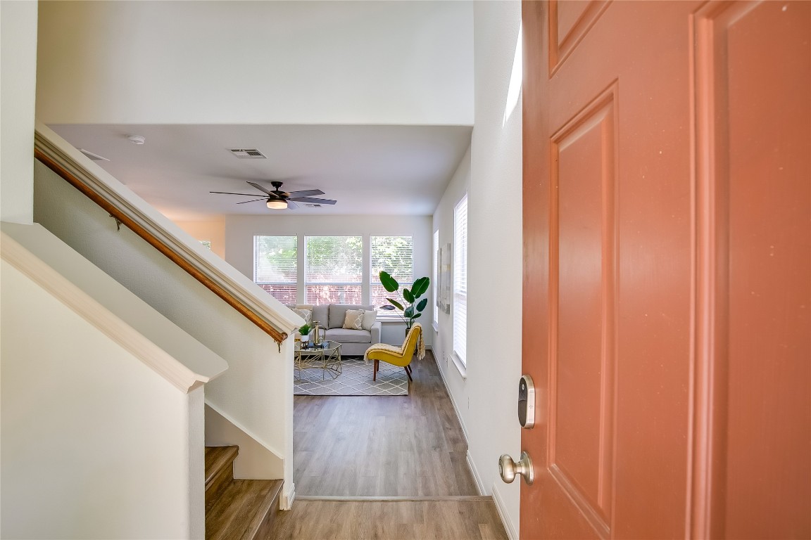 2410 Great Oaks Drive, Unit 804 Round Rock, TX 78681 - Photo 6 of 37 a hallway with wooden floor and furniture