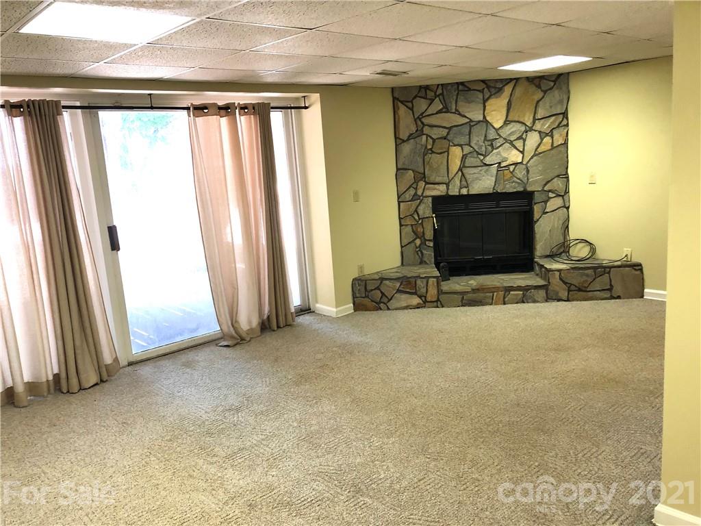 4516 Kiser Island Road Terrell, NC 28682 - Photo 16 of 19 an empty room with a fireplace and painted walls