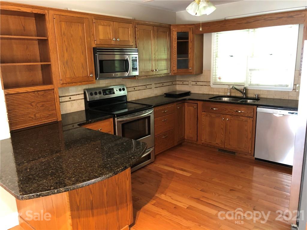 4516 Kiser Island Road Terrell, NC 28682 - Photo 6 of 19 a kitchen with stainless steel appliances granite countertop a stove a sink and a microwave