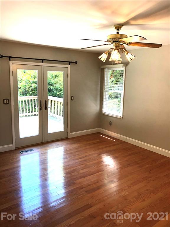 4516 Kiser Island Road Terrell, NC 28682 - Photo 7 of 19 a view of an empty room with wooden floor and a window