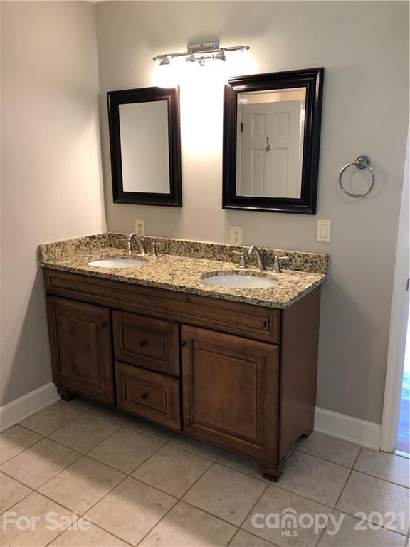 4516 Kiser Island Road Terrell, NC 28682 - Photo 9 of 19 a bathroom with a double vanity sink and a mirror
