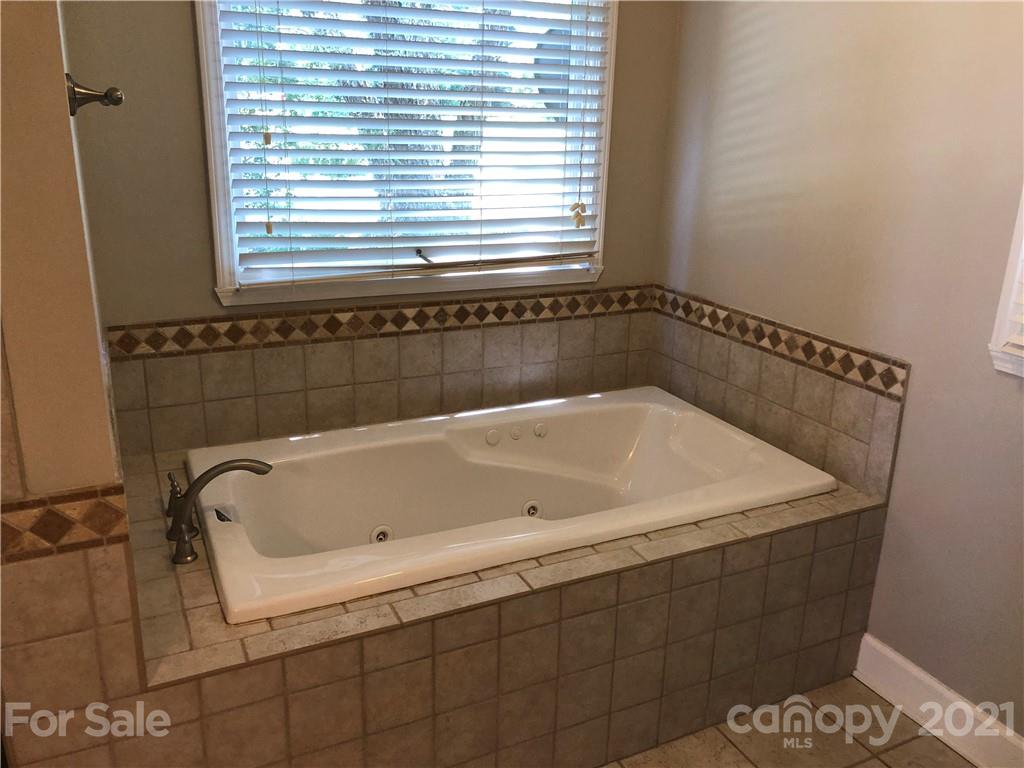 4516 Kiser Island Road Terrell, NC 28682 - Photo 10 of 19 a bath tub sitting in a bathroom next to a window
