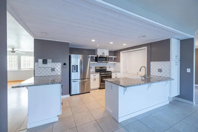 a view of a hallway with wooden floor and entryway