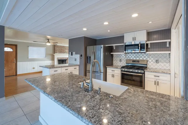 a kitchen with stainless steel appliances a sink and cabinets