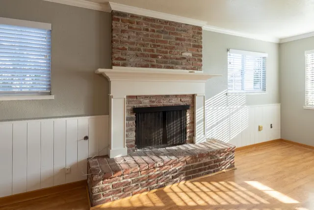 a view of a livingroom with a ceiling fan and window