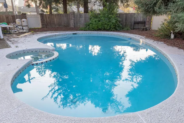 an aerial view of a swimming pool patio and outdoor seating