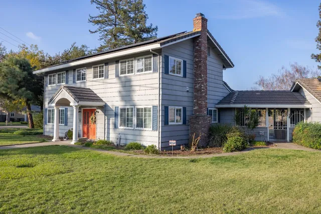 a view of livingroom with hardwood floor and a kitchen