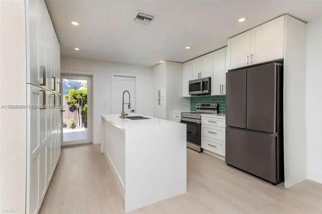 a kitchen with a refrigerator a sink and dishwasher
