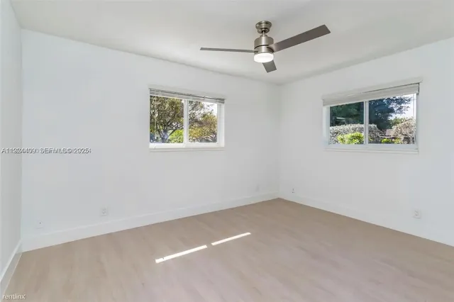 a view of room with window and ceiling fan