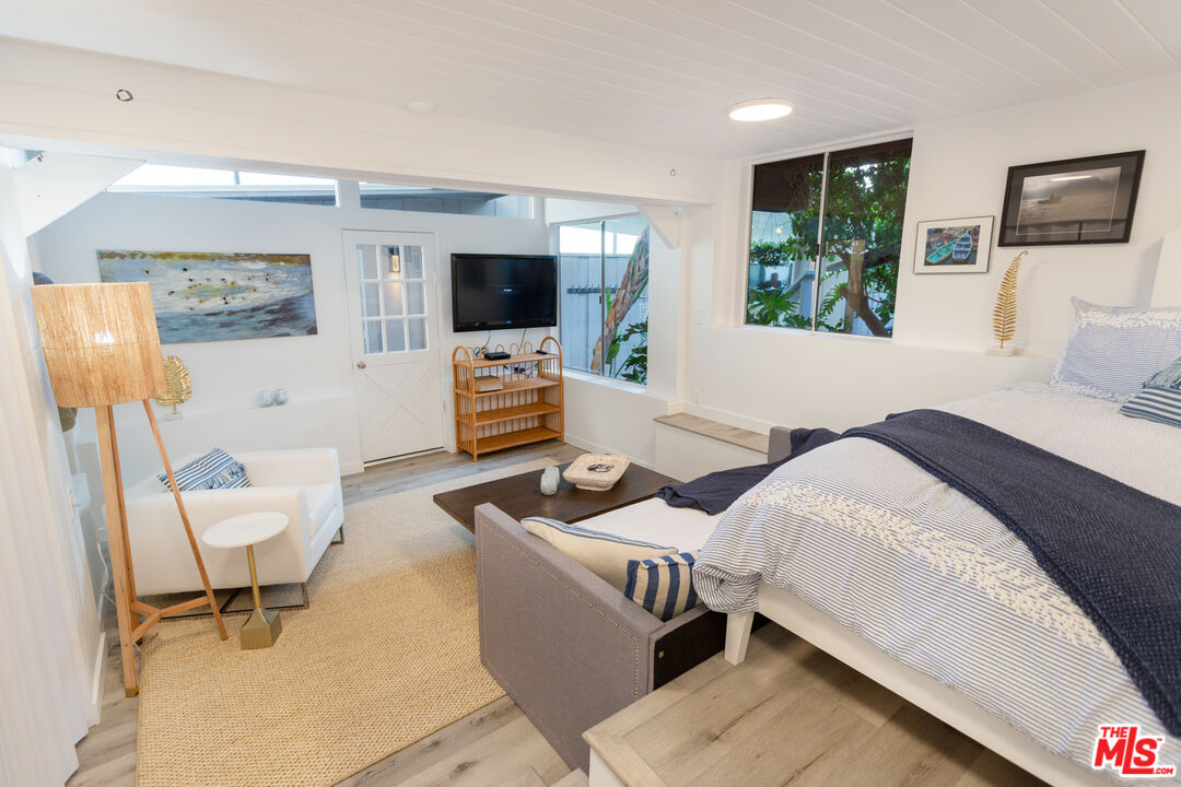 24246 Malibu Road Malibu, CA 90265 - Photo 17 of 20 a living room with furniture and a flat screen tv