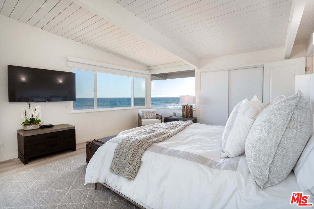 24246 Malibu Road Malibu, CA 90265 - Photo 7 of 20 a bedroom with a bed and a flat screen tv