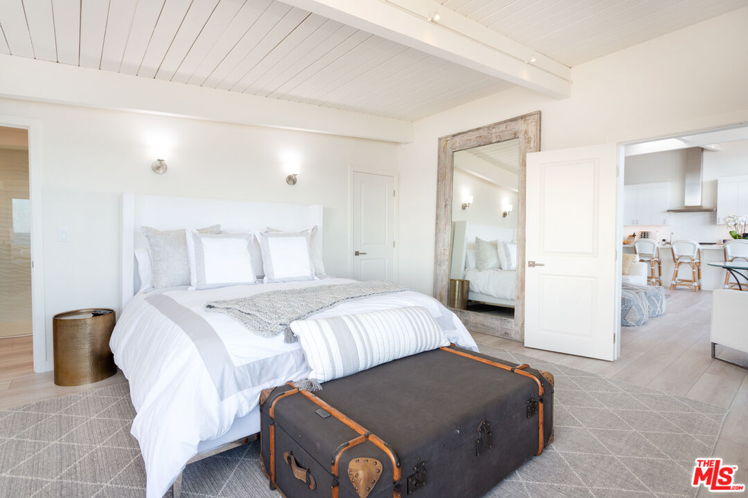 24246 Malibu Road Malibu, CA 90265 - Photo 8 of 20 a bedroom with a bed and a table