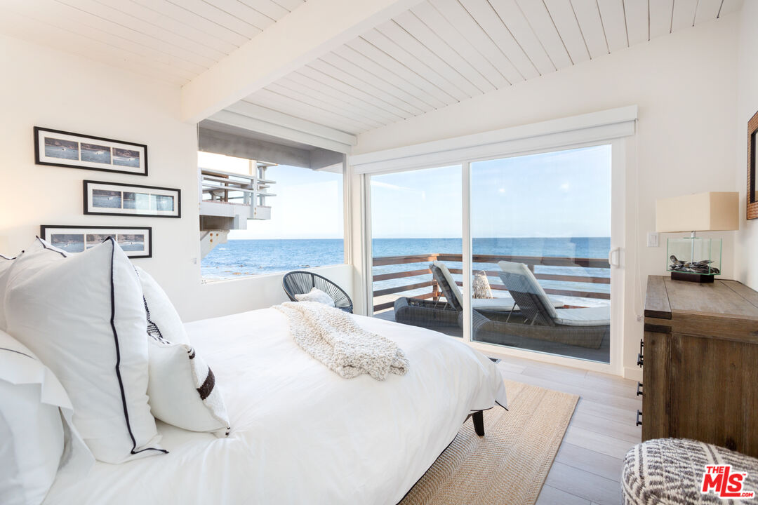 24246 Malibu Road Malibu, CA 90265 - Photo 10 of 20 a bedroom with a bed and a large window